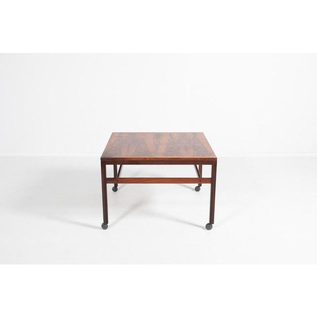 Vintage rosewood veneer coffee table from 1970s produced by Haslev Mobelfabriek, equipped on wheels. Condition Fair, some...