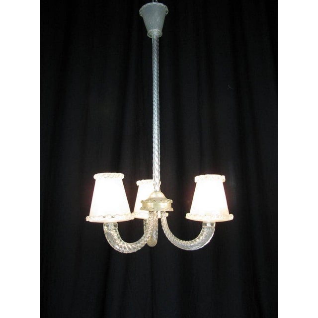 Antique Venetian chandelier in clear blown Murano glass with regular inclusions of air bubbles in the Barovier style; a...