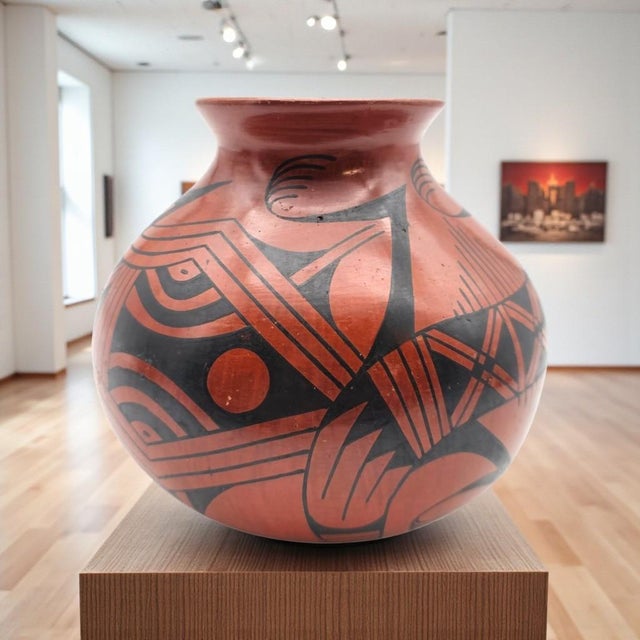 A signed Mata Ortiz pottery vase by Lupe Soto, executed in the traditional black-on-red palette central to the Casas...