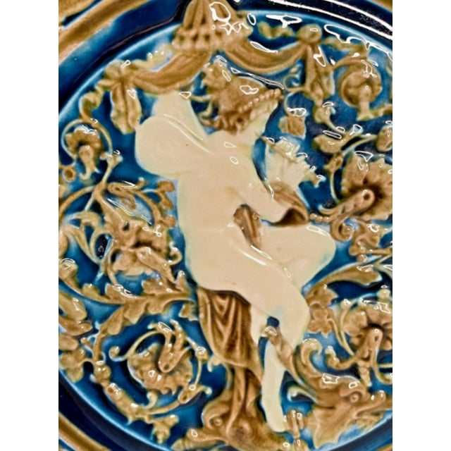 Beautiful plate showing a winged flutist a surrounded by putti on the edge of the plate. Created by Schütz Blansko in...