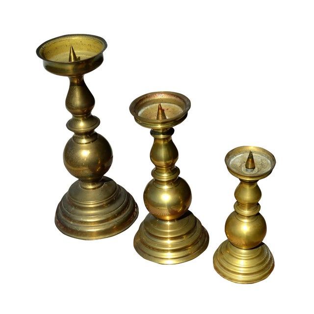 This is a set of 3 candleholders that graduate in size. They're cylindrical in shape.