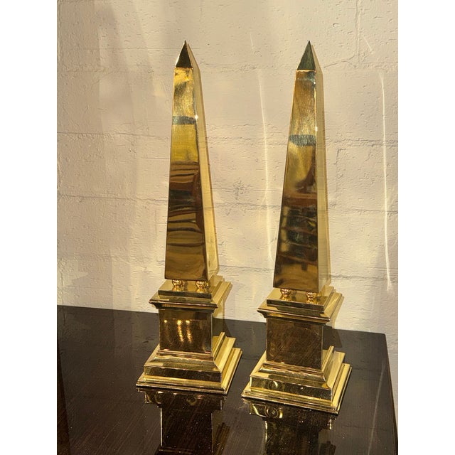 The product is a pair of Continental polished brass obelisks. These obelisks are decorative and unique, adding a touch of...