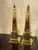 The product is a pair of Continental polished brass obelisks. These obelisks are decorative and unique, adding a touch of...