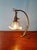 Art Nouveau table lamp in bronze and brass with an opalescent glass shade, circa 1900. This articulated lamp has been...