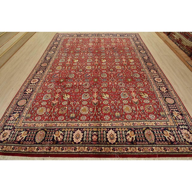 An authentic vintage traditional Tabriz rug hand-knotted with fine wool and natural dyes. This intricately woven oriental...