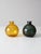 Pair of late 20th century recycled glass vases in amber and deep green. Each mouth-blown with subtle shape variation and...
