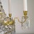 An empire 6 arm chandelier in polished brass with haand cut crystals and a basket bottom. There are 7 internal fittings...