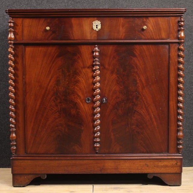 Dutch sideboard from the second half of the 19th century. This piece features two doors and a carved drawer, crafted from...