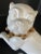 Fantastic stylized porcelain pug with lifted paw in ivory with matte gold collar. A classic traditional look. Beautiful...