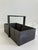 Rustic vintage wooden tote with one compartment and a central handle, finished in a dark painted patina. Likely dating...