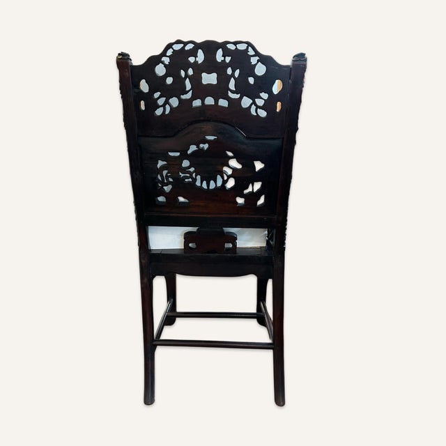 Chinese carved decorative rosewood armchair with stone seat. This chair style, from the late Qing Dynasty, is a Chinese...