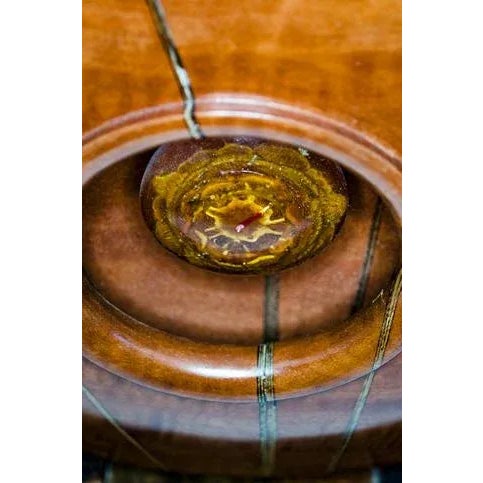 This sculpture is made of Eucalyptus and splatted Walnut woods. The centerpiece is a casting of a Sweetgum Tree Pod....