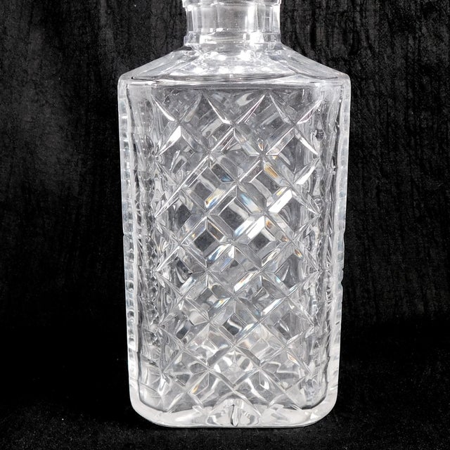 This is a square cut crystal decanter. Two sides are cut in a diamond pattern while the other two sides are cut in a...