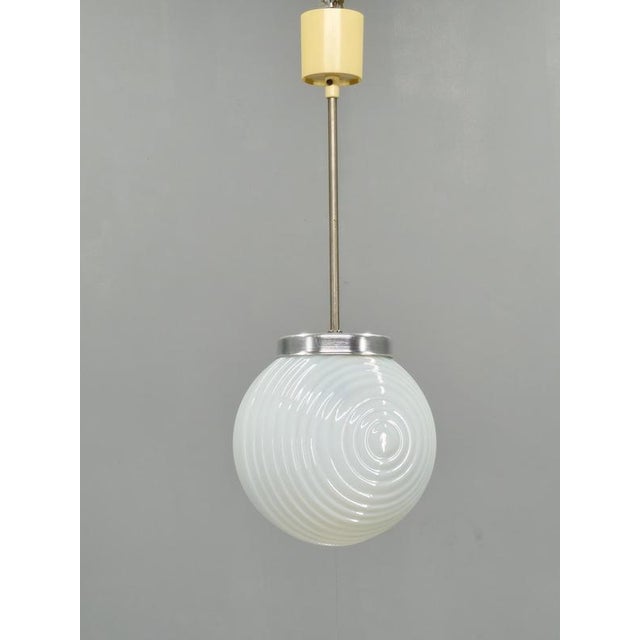 Elegant pendant light produced in czechoslovakia during the 1970s. The design features a beautifully proportioned opaline...