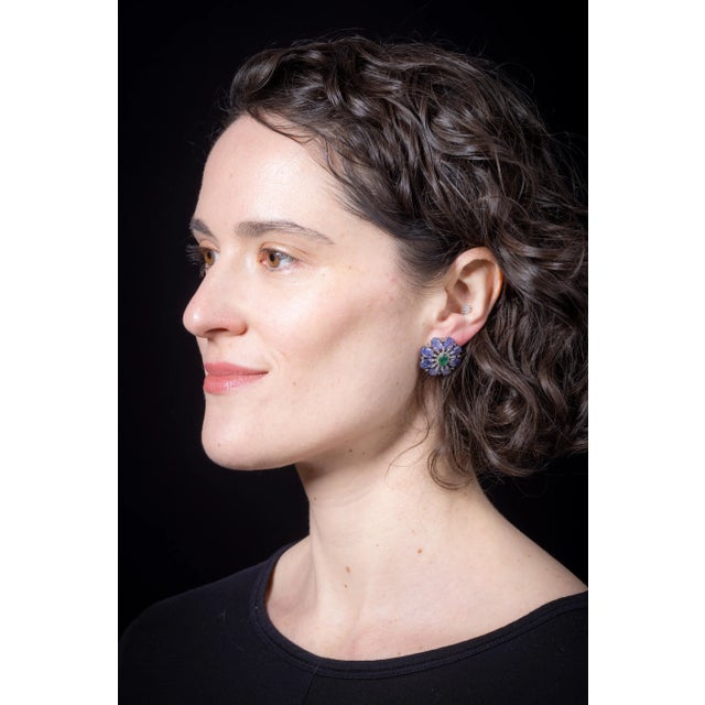This is part of Chairish’s Fine Jewelry assortment. A stunning pair of faceted oval tanzanite stones interspersed with...