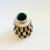 A mid century West German Pottery vase. Textured checkered white and yellow pattern over a black and tan base glaze....