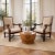 A grand pair of oversized Neoclassical revival armchairs hand-carved from rich mahogany. Featuring dramatic rolled scroll...