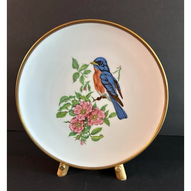 Decorative porcelain plate with matching gold stand. Measures 8”.