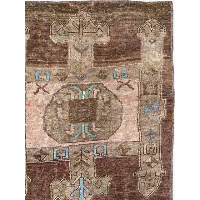 This Mid-20th century Turkish Anatolian accent carpet presents an imaginative, highly stylized composition arranged across...