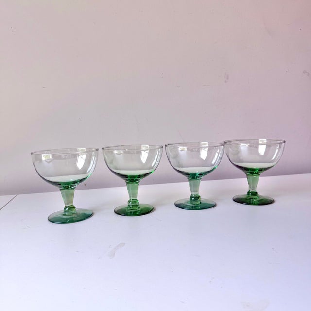 Set of four blown glass coupe cocktail glasses in a lovely sea green color.