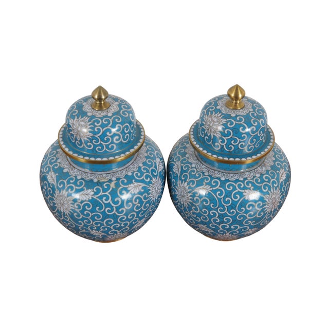 Pair of antique cloisonne ginger jars with lids featuring a design of chrysanthemums and swirling tendrils in white on a...