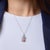 This captivating Art Deco charm necklace showcases a beautifully intricate composition of gemstones, centered around 29...