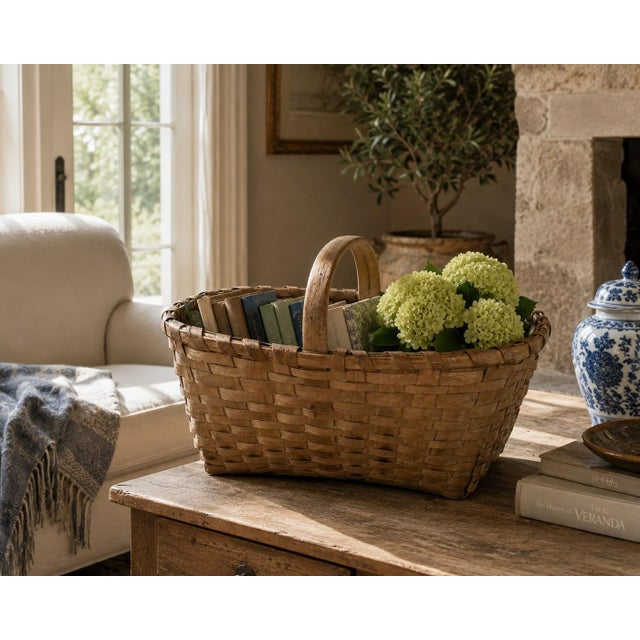 A beautifully woven early 20th century American splint oak basket with warm honeyed tones and a tightly constructed...