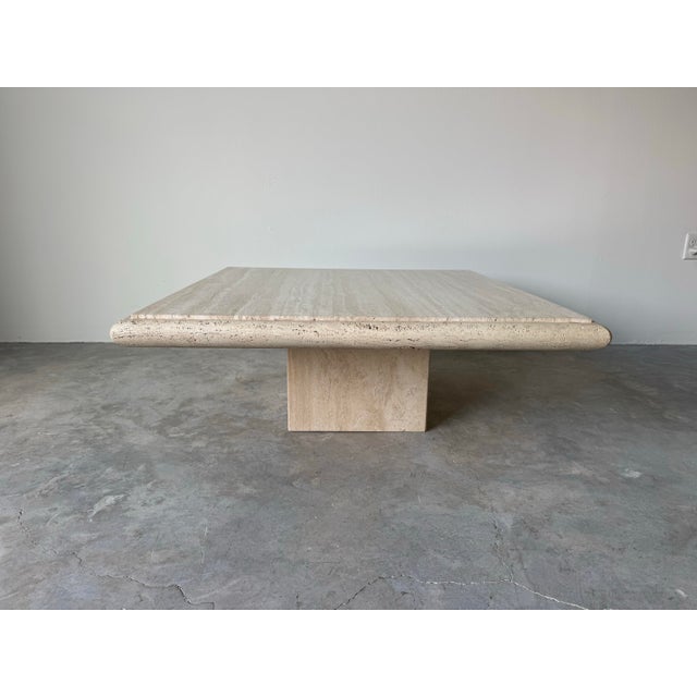 A stunning 1980s Italian Postmodern travertine coffee table by Stone International, showcasing masterful craftsmanship and...
