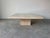 A stunning 1980s Italian Postmodern travertine coffee table by Stone International, showcasing masterful craftsmanship and...