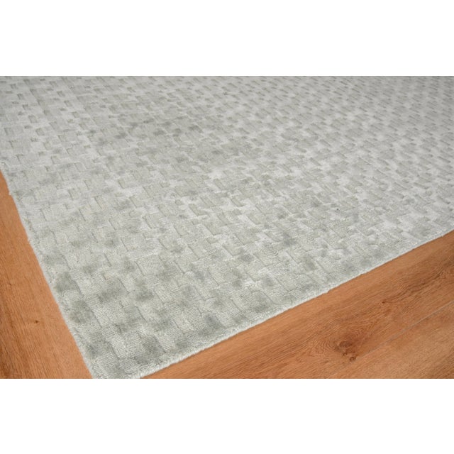 The versatility of a solid color rug with a little more intrigue. A mix of high and low geometric shapes gives the Monroe...