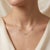 Enchant your style with this luminous cluster pendant necklace, featuring three glowing, mystical gemstones set in an...
