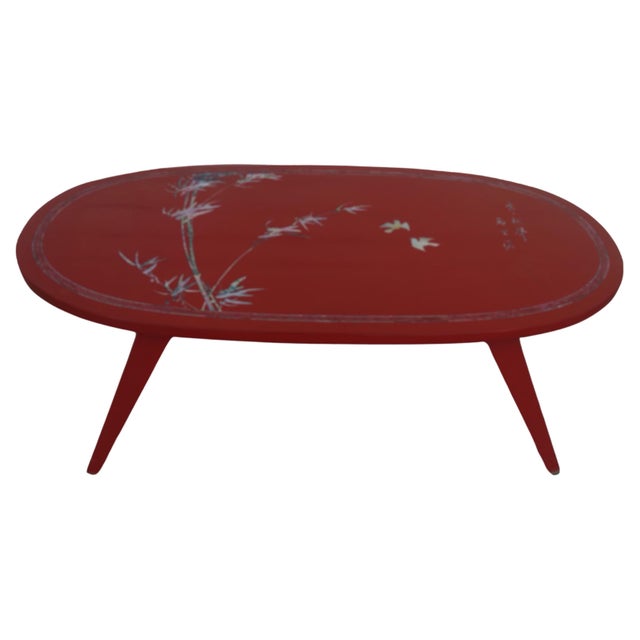 This is a folding coffee table painted in red lacquer. It has mother of pearl inlay. Has a matching red lacquer tray that...