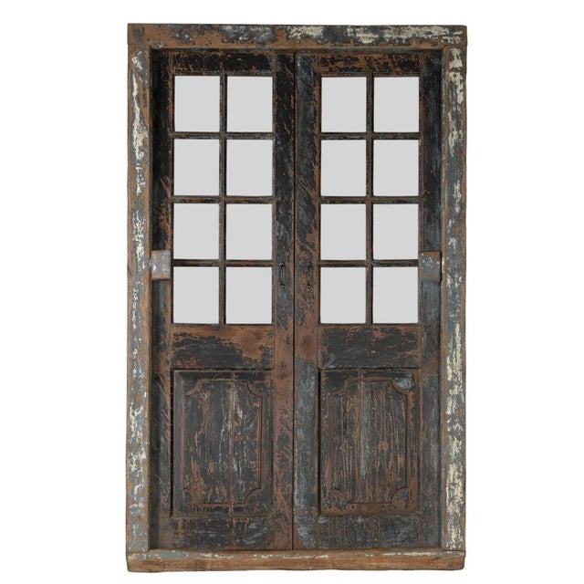 This Antique Indian Painted Teakwood and Glass Door with Frame is constructed from solid teakwood, featuring rustic double...
