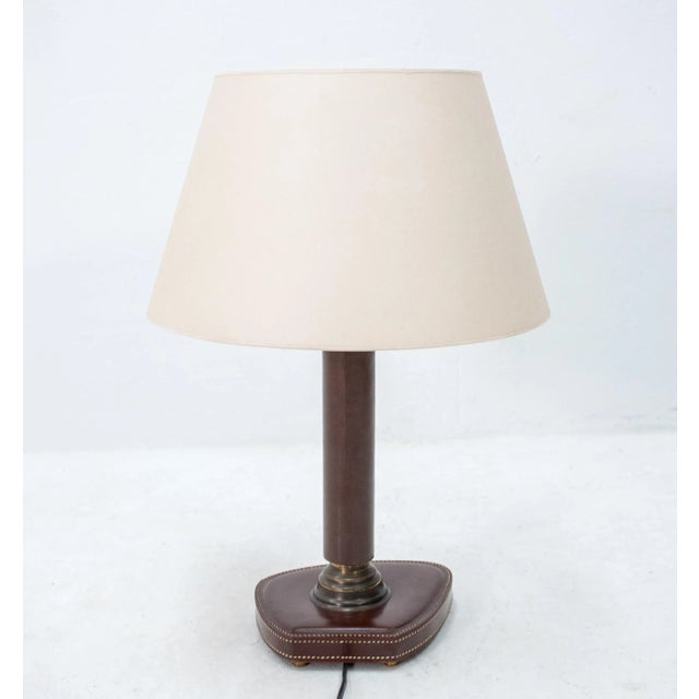 Stitched leather desk lamp in the style of Jacques Adnet. Good condition, French, 1960s, recently rewired. European Plug...