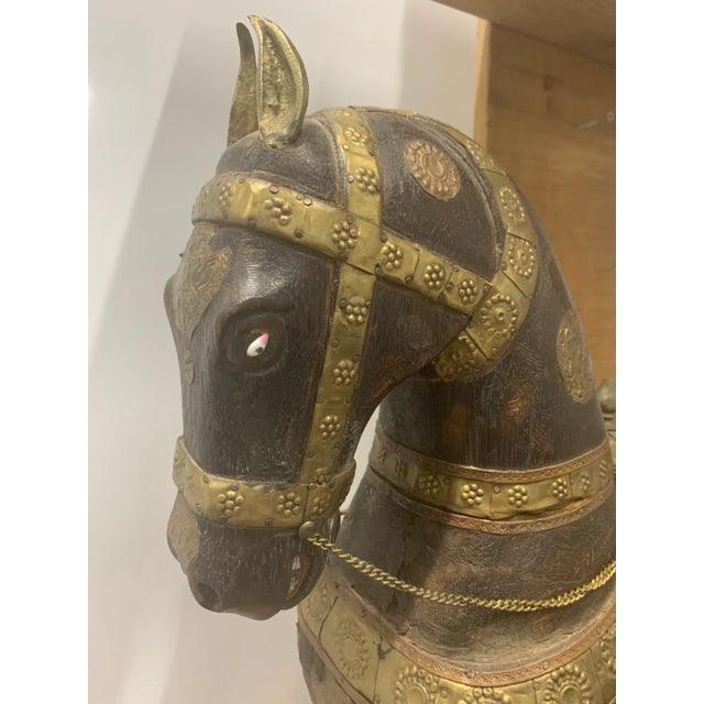 A large finely pressed copper and brass clad carved wooden horse. Richly decorated throughout with elaborate embossed...