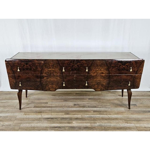 Italian chest of drawers of the early 1950s with a beautiful marbled effect glass top and a very particular design with...