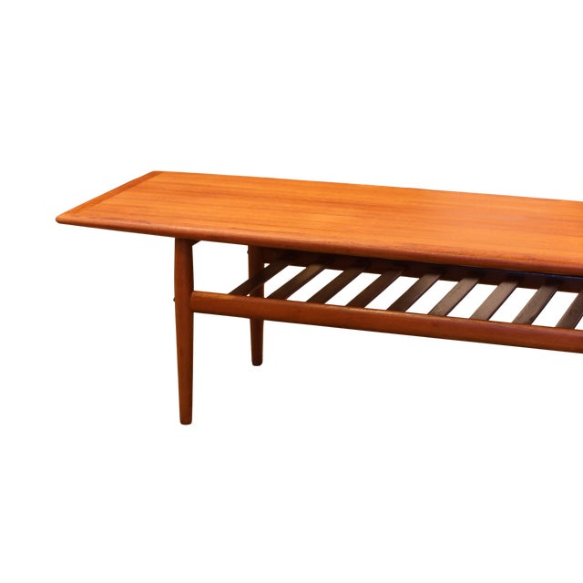 A stylish Danish coffee table in teak, designed by the famous designer Grete Jalk for Glostrup Møbelfabrik in Denmark. The...