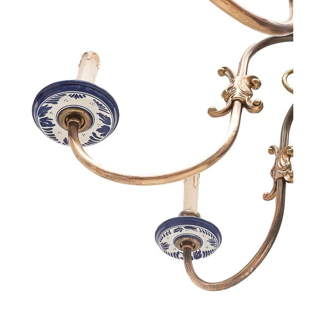 Dutch 8-light chandelier. Brass branches. Double-headed corner at the top. Delft blue earthenware body and cups....