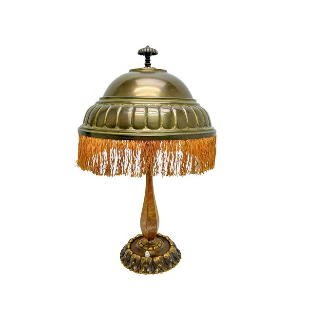 This lamp is a typical example of the transition from Late Art Nouveau to Early Art Deco. The brass lampshade with its...