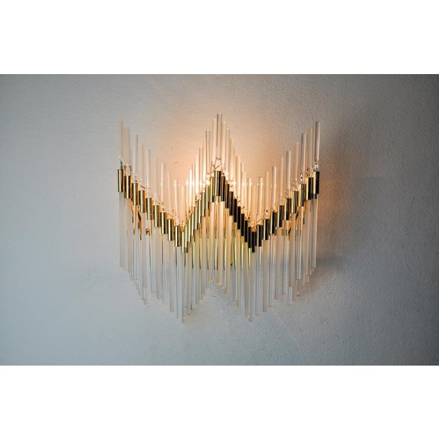 Very beautiful venini wall lamp produced in italy in the 70s. Tubular crystals spread over a gilded metal structure....