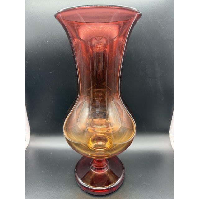 Blown glass vase in Amberina style, from the 1960s, featuring nuanced colors ranging from bright red at the top to amber...