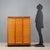 Storage unit, with internal shelves, shutter openings, walnut veneer and Formica top. This piece is attributed to the...