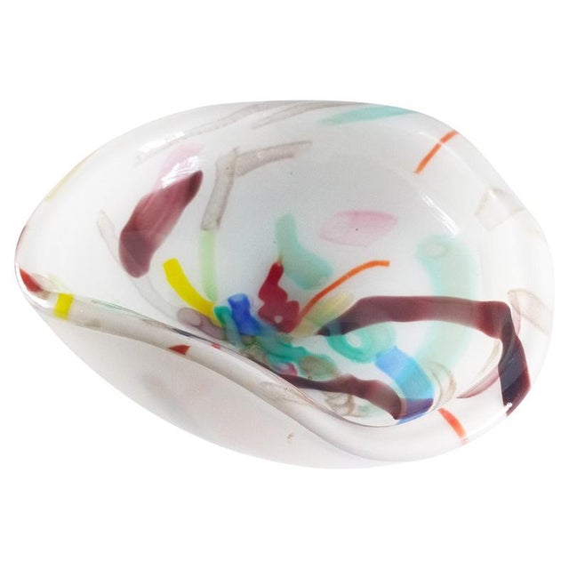 This Murano glass bowl in lattimo and aventurine, produced in Italy circa 1960, is a refined example of mid-century...