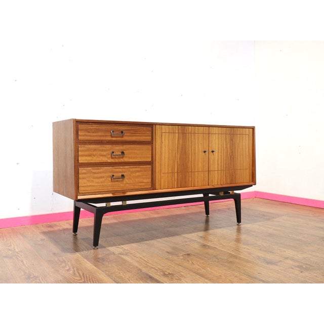 Experience timeless elegance with our beautiful mid century modern credenza by renowned British furniture maker Nathan,...