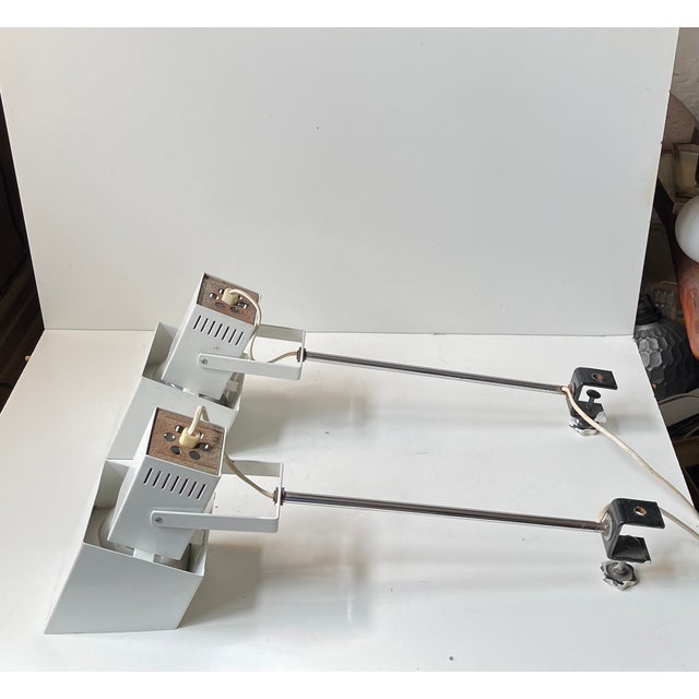 A pair of adjustable wall or clamp lights fashioned from powder-coated steel and chrome-plating. An eye-catching design...