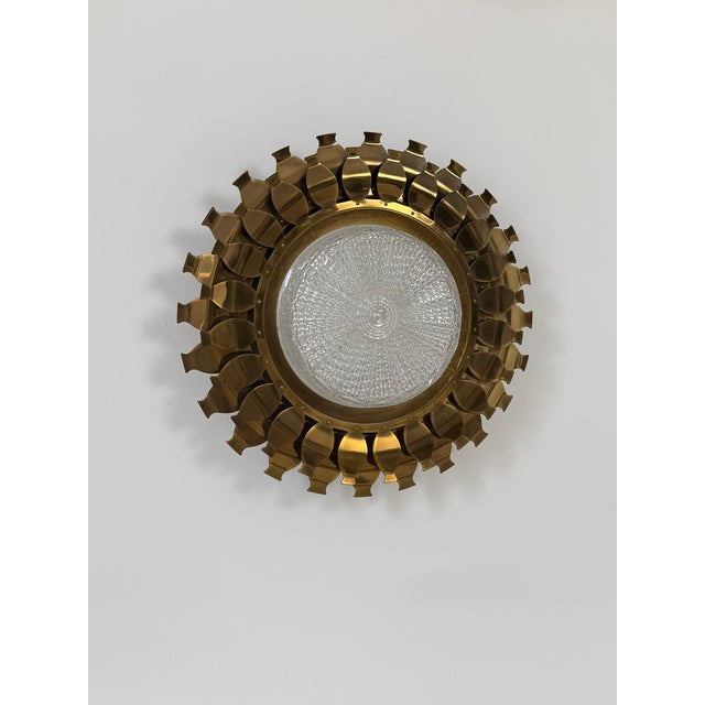 Rare vintage wall light composed of a brass frame and a pressed glass diffuser, produced in Sweden in the 1960s. It...