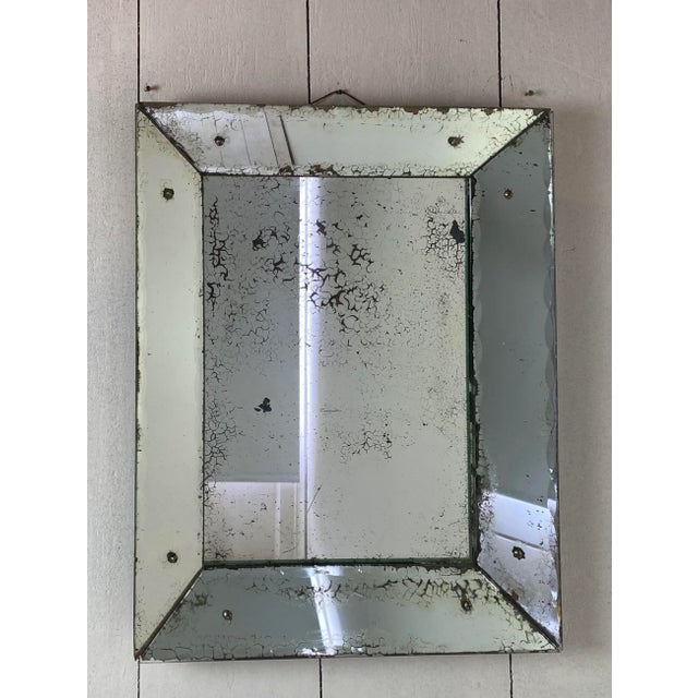A very characterful antique Mercury glass mirror, late 19th century. The edges are cut in a wavy pattern. The glass is...