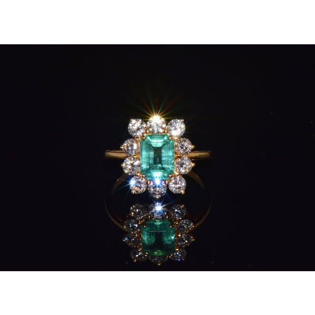 Certified 2.73CTS diamond and emerald solid 18K yellow gold ring. This elegant ring features a 1.43CT natural emerald-cut...