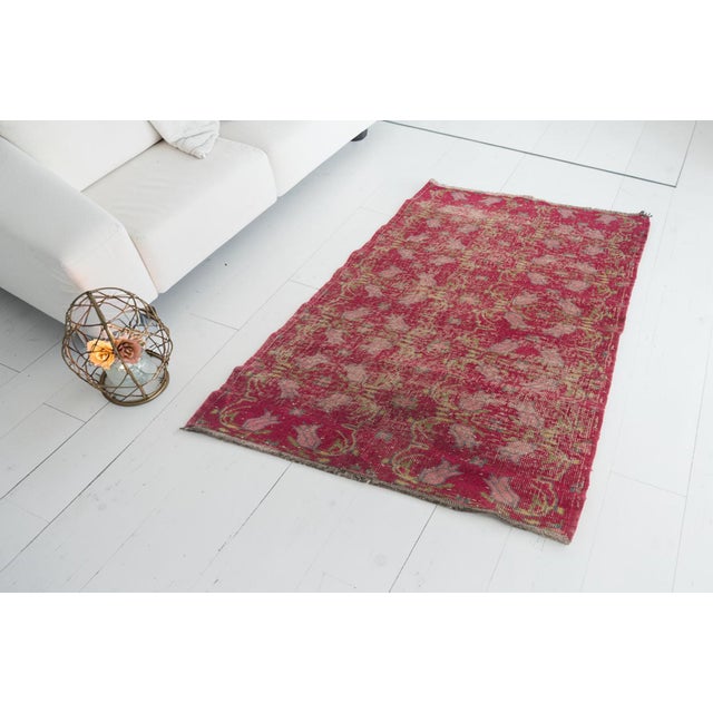 This is a vintage Turkish Oushak rug from the Mid 20th Century. The piece was hand-knotted.