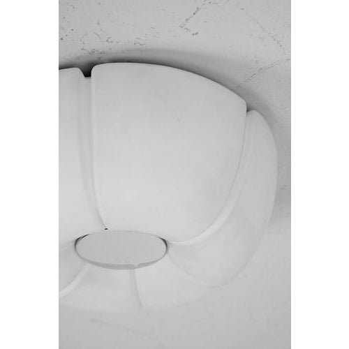 Glashütte Limburg model Lotus lamp. This ceiling lamp could also be used as a wall lamp. It is made from milk glass and...